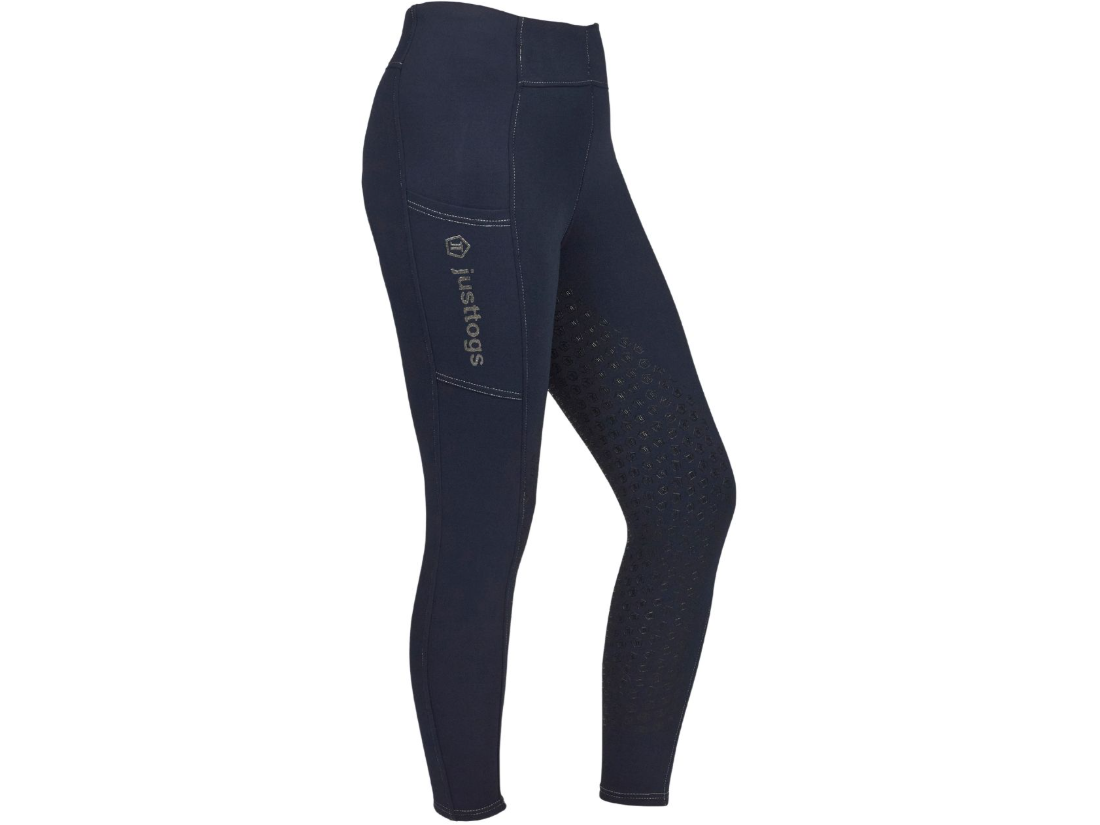Navy blue equestrian riding tights with a textured grip pattern on the seat and thigh, featuring a side pocket with the 'justtogs' brand logo printed vertically.