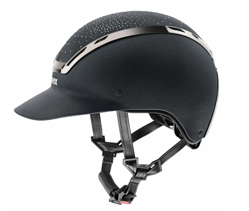 A black equestrian riding helmet with a visor, featuring a metallic silver accent stripe and a small white brand logo on the side, set against a plain white background.