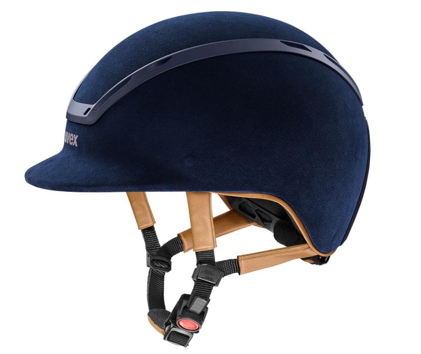 A matte navy equestrian riding helmet with a visor, featuring a textured fabric shell, a glossy black trim strip, and adjustable black straps with a red release button, shown on a solid white background.